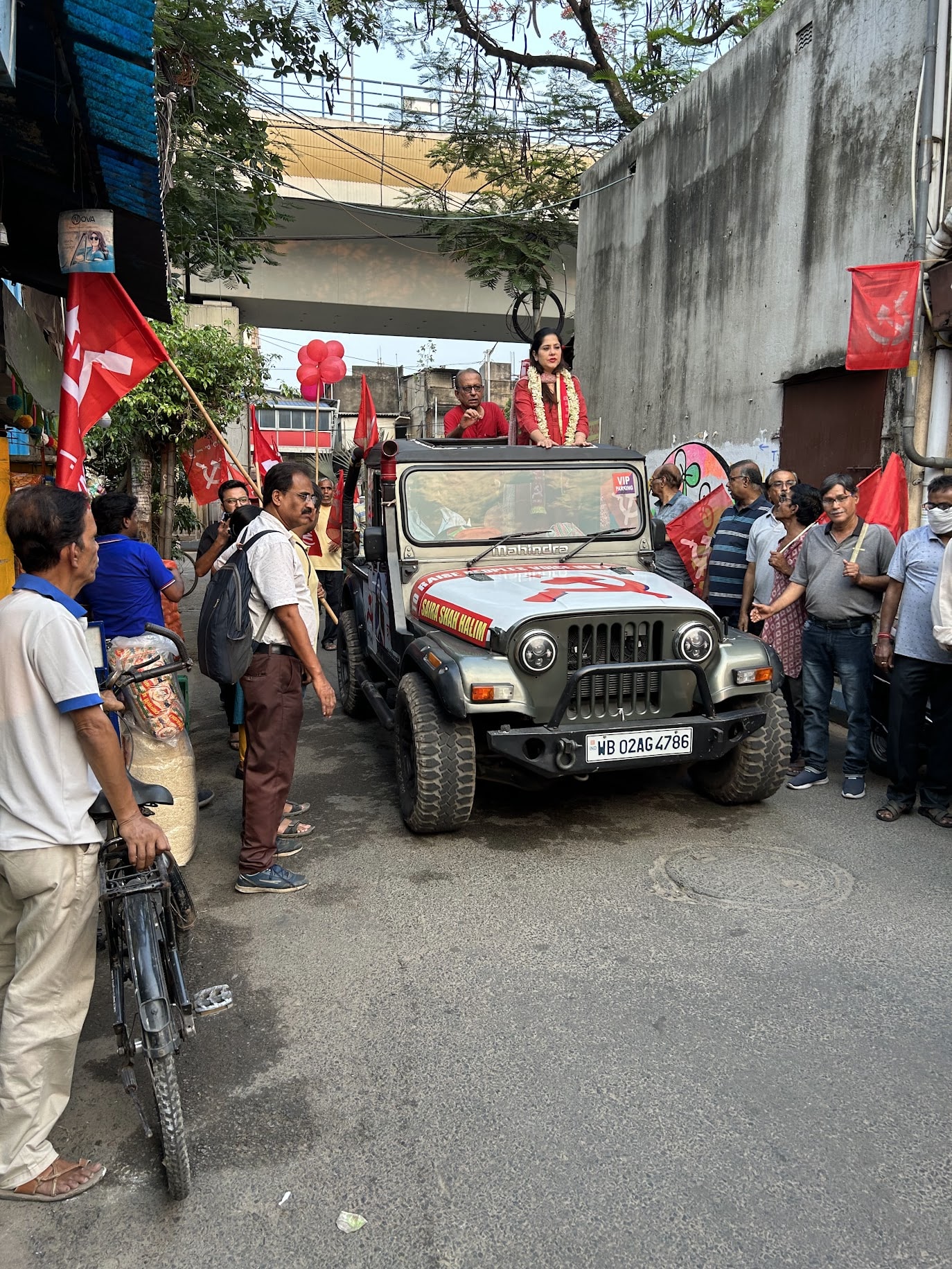 A photo of the author with a flag of the Communist Party of West Bengal.
